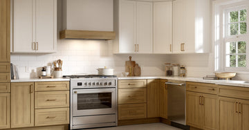 Elegant custom shaker-style kitchen featuring warm wood-tone lower cabinetry, white upper cabinets, premium countertops, and a timeless design that blends natural warmth with modern functionality.